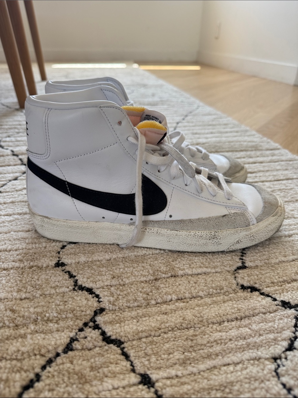 Nike White High-Top Sneakers with Black Swoosh and Yellow Tongue